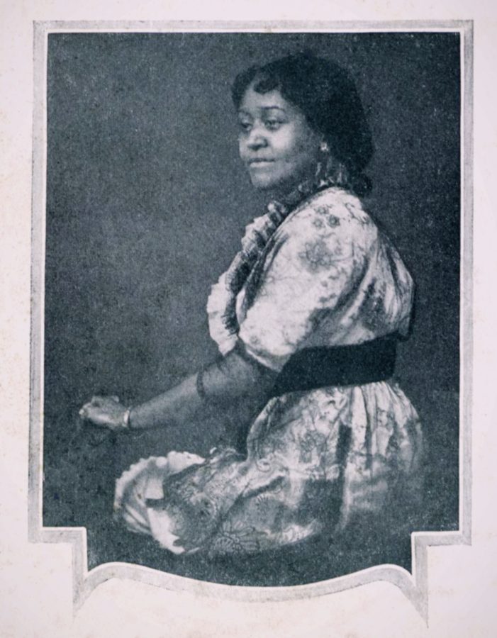 Black and white photograph of Annie Turnbo Malone seated in a patterned dress